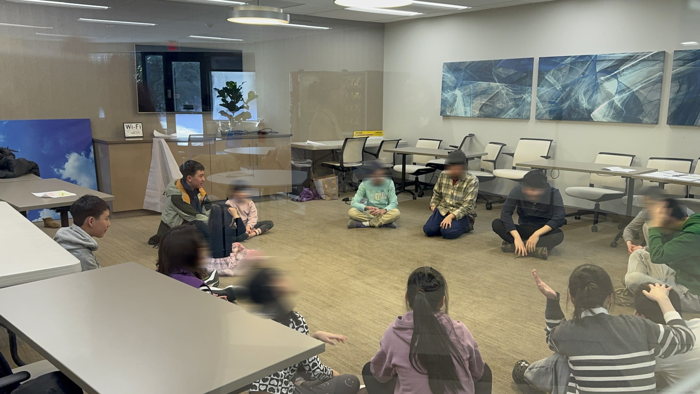 Participants seated in a circle during a Music and Movement group activity